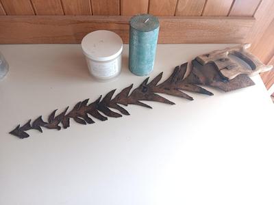 Saw blade pine tree art with candles scented candle in a jar and pillar candle.