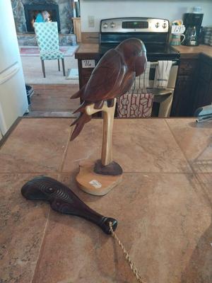HAND CARVED WAR CLUB AND A PERCHED PARROT