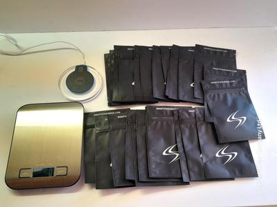 Digital food scale - POM Gear Phone charger - and a few smart stash brand bags.