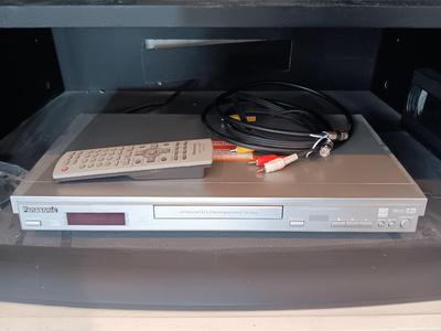 Panasonic DVD Player with remote control and an assortment of DVD videos