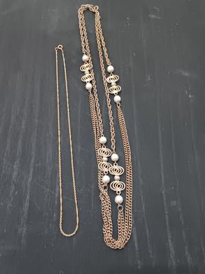 Two gold toned necklaces.