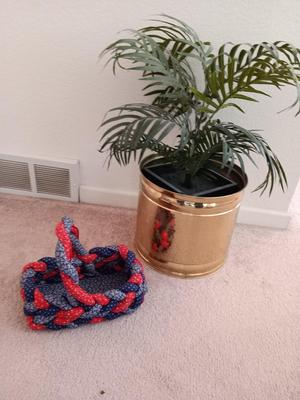 Faux palm tree in brass pot and a fabric woven basket