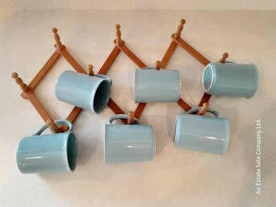 Six matching Corning Mugs with wooden wall hung mug holder.