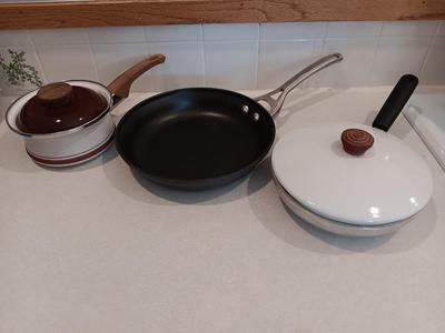 Kitchen cookware - skillets and a sauce pan with lid