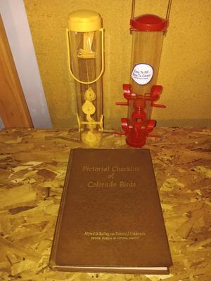 Hardback Pictural checklist of Colorado Birds Alfred M. Balley with two bird feeders