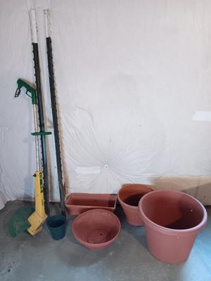 Plastic flowerpots - two T posts and an electric weed eater