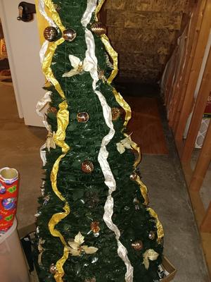 Neat collapsing Instant Christmas tree - decorated and light up with wrapping paper in storage tote