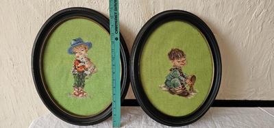 Pair of oval needlepoint framed pictures of children playing with puppies!