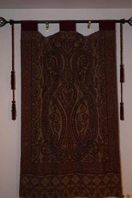 Antique Paisley shawl on display rod. 
