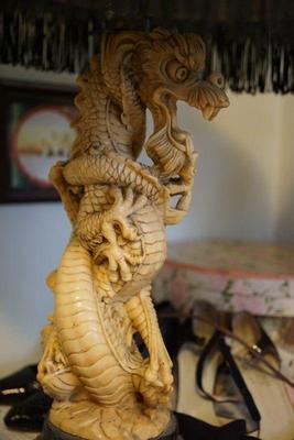 This is a unusual vintage lamp in the form of a dragon intricate  carved of 
