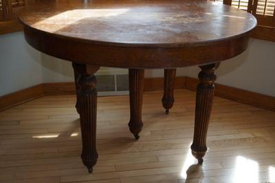 antique oak round oak table with fluted legs has 4 leaves. There is another oak round table with a nice double column style base. two...