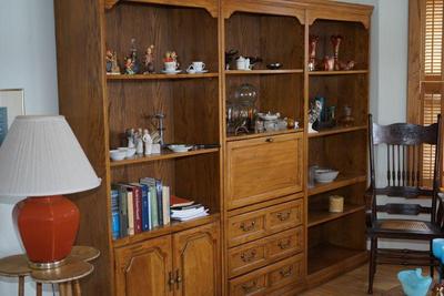 Three piece oak wall unit. the center has a drop down desk. Lots of storage with cabinets and drawers. Keep as one or use two of the units. 