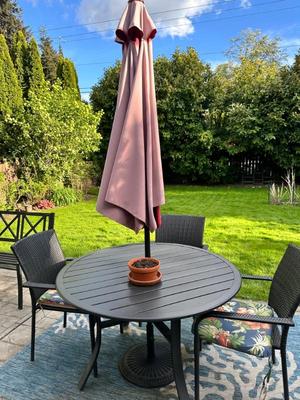 Patio table with umbrella and chairs