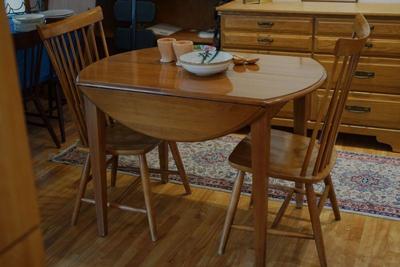 Cherry drop leaf table with two maple side chairs. 