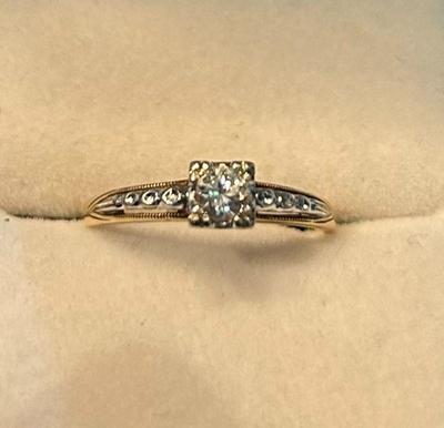Brilliant cut diamond ring 0.20 carat set with small stones set in 14K gold. Appraisal provided. 