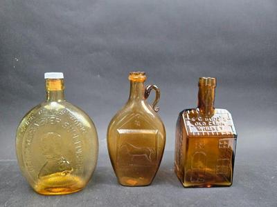 Three Amber Glass Decanters - Empire Glass Works, Flora Temple Harness Trot, E C Booz's Old Cabin Whiskey
