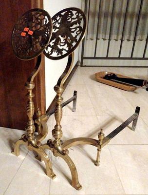 Pair arts & crafts brass andirons,  upright topped with a pierced openwork brass floral scroll medallion
