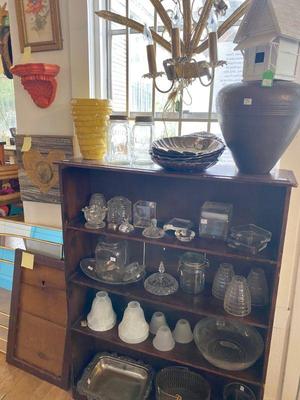 antique wooden bookcase filled with odds and ends