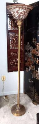 A brass torchiere floor lamp