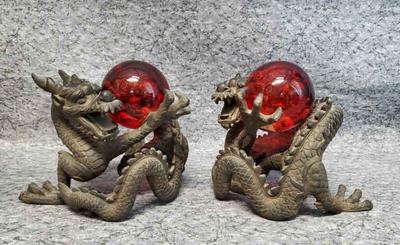 Chinese dragon stand with red art glass paperweights