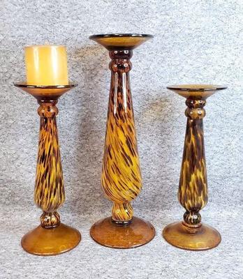 3 amber art glass pillar candle stands