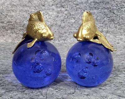 Brass beta fish on cobalt blue glass paperweights