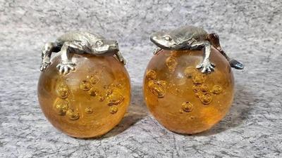 Pewter lizards on amber glass paperweights
