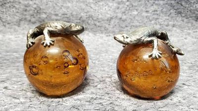 Pewter lizards on amber art glass paperweights