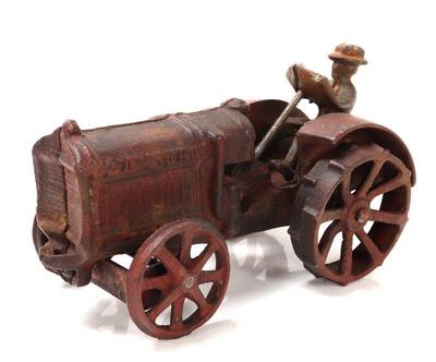 Lot 498 cast iron mechanical tractor toy with driver