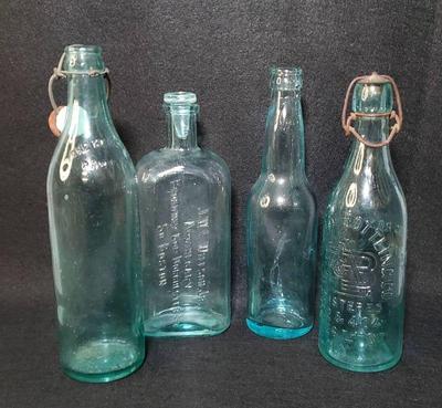 Turquoise glass beverage and apothecary bottles