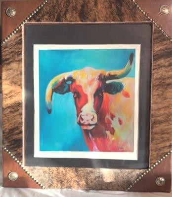 Colorful cow in a leather and cowhide frame
