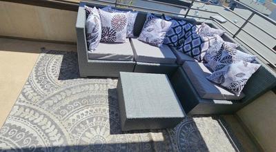 OUTDOOR RATTAN SOFA, TABLE, PILLOWS & RUG