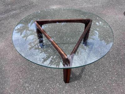 Round glass coffee table with triangular base