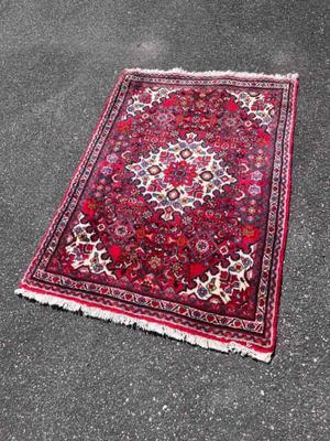 Red area rug with white diamond center