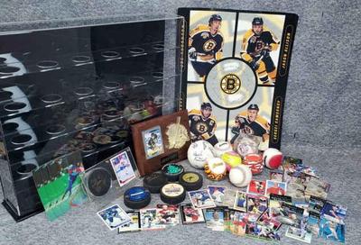 Hockey and baseball memorablia signed pucks, ball display