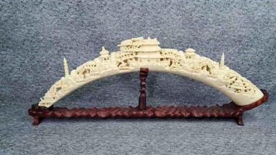 Asian carved resin tusk bridge sculpture on stand