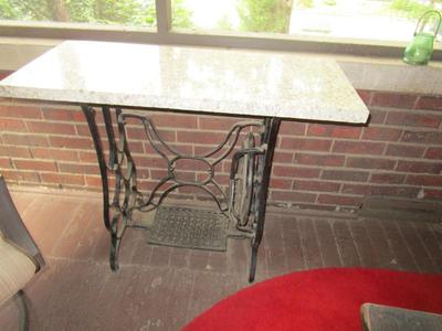Table - Old sewing machine base with marble top.  All weather so great for a porch.
