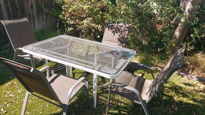 OUTDOOR METAL FRAME GLASS TOP TABLE AND FOUR CHAIRS