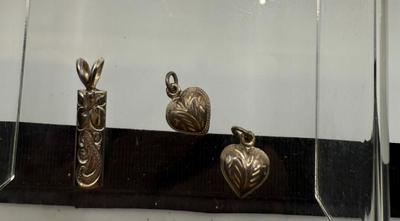 Sterling Silver Engraved Hawaii Pendant- Plumeria & Gecko & Pair Engraved Silver Heart Charms- 2.22 Grams
Lot #: 45