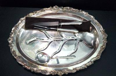 Silverplated roast platter with carving utensils and serving spoon