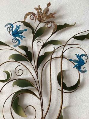 Metal wall sculpture featuring floral and leaf motifs