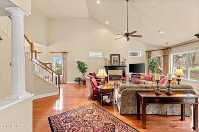 Sale Photo Thumbnail #3: Living room has matching couches, lamps, end tables and a coffee table with leather, glass and metal.