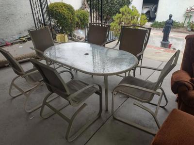GLASS TOP PATIO TABLE AND SIX CHAIRS