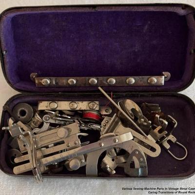 Various sewing machine parts in vintage metal case