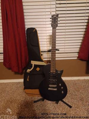 Black electric guitar with guitar stand and travel case 1