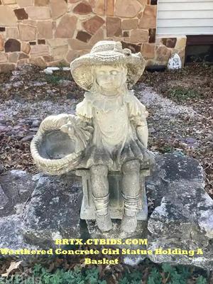 Weathered concrete girl statue holding a basket rrtx ctbids.com