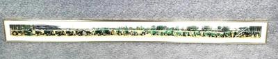 Panoramic photo of a long line up of john deere tractors