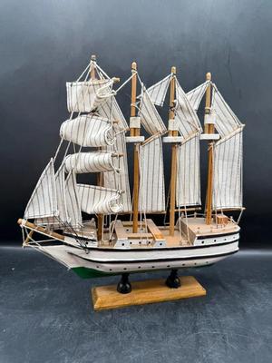 Handcrafted Wooden Sailing Ship Model with Striped Fabric Sails on Display Stand