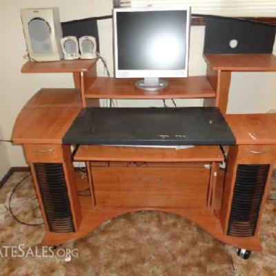 Large office desk with computer extras

-Medium wood color -Hidden file cabinet -Includes: HP vs19 monitor, HP keyboard, HP mouse, Altec...