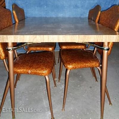 Vintage Dinning Table with 4 Chairs

-Dark wood color -Includes 2 leaves -4 Matching chairs; gold & brown colors (all needs Cleaned)...